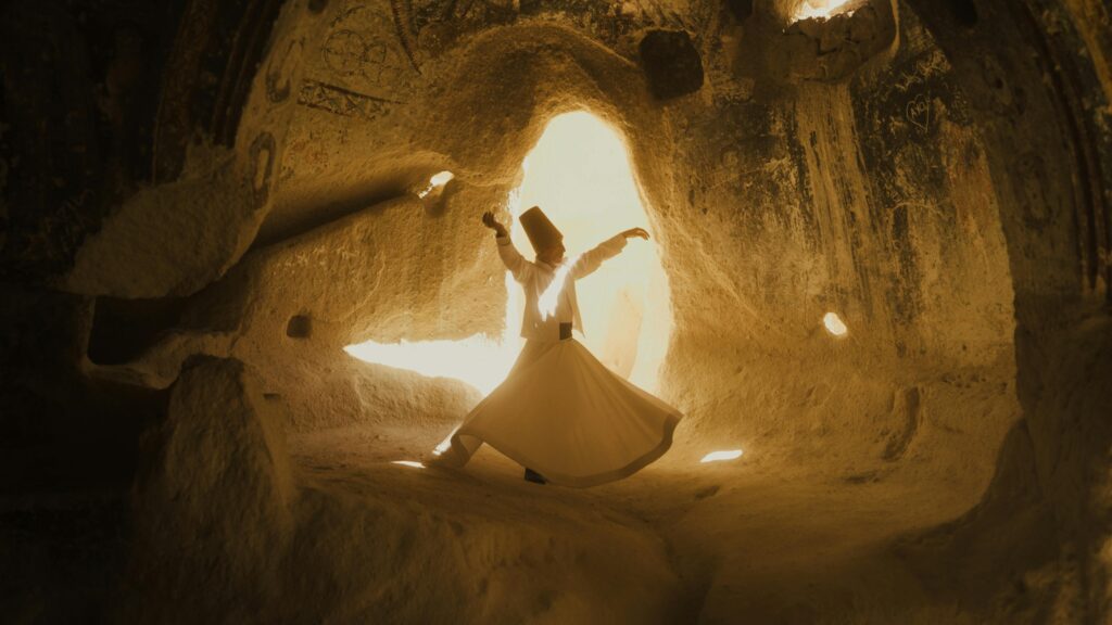 A whirling dervish dances in the mystical caves of Cappadocia, Türkiye.